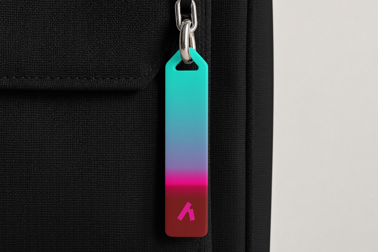 Close-up view of a metal zipper puller and teeth on a fabric background.