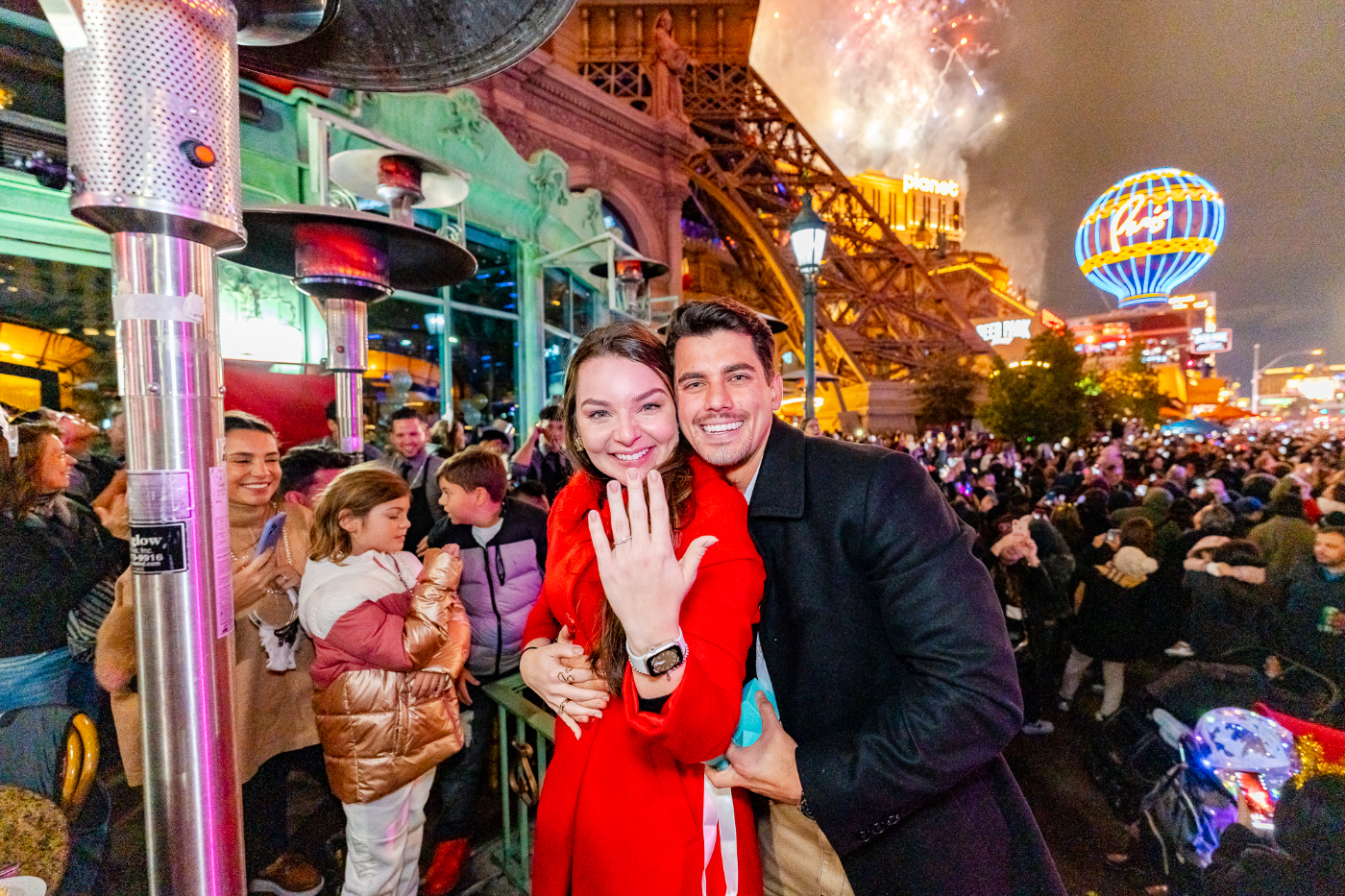 A couple celebrating their new year's eve engagement on Mon Ami Gabi's patio.