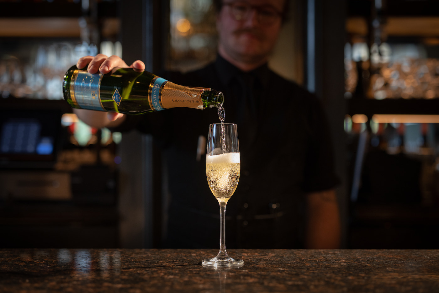 A glass of champagne being poured at Mon Ami Gabi, available on New Year's Eve