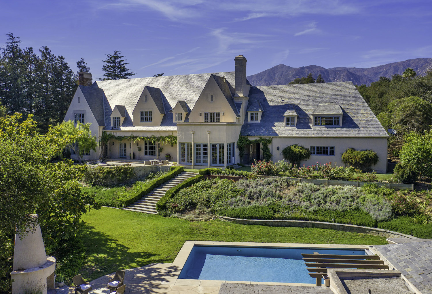 An enchanting estate surrounded by mother nature with the blue sky above.