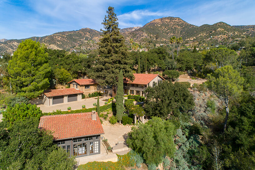 Montecito Estate with red tile roofs surrounded by trees. 