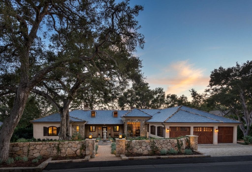 front view of a French country-style home in Montecito at twilight