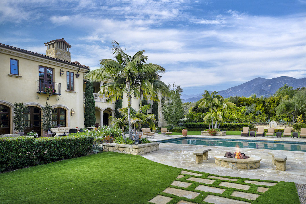 Blue sky and white fluffy clouds above a Premier Mediterranean-style Ennisbrook Estate