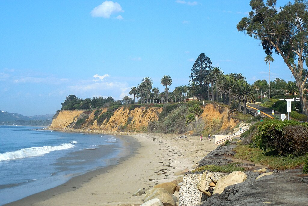 Butterfly Beach in Montecito with lush greenery on the cliffs.