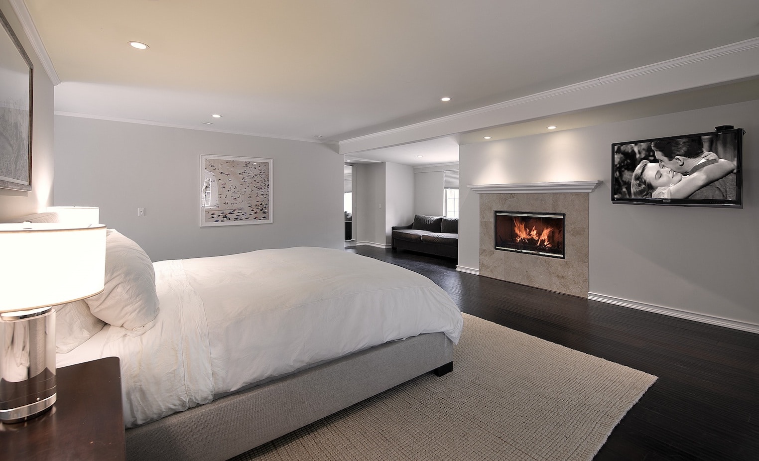 A welcoming bedroom with the fireplace adding to the luxury ambiance