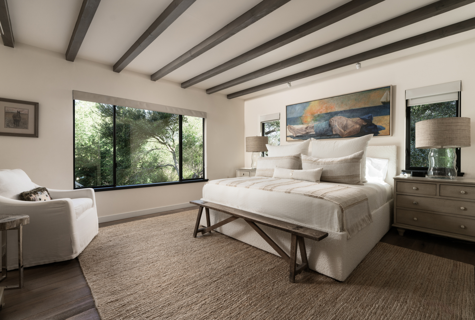 A luxury primary suite with windows that bring the outside in.