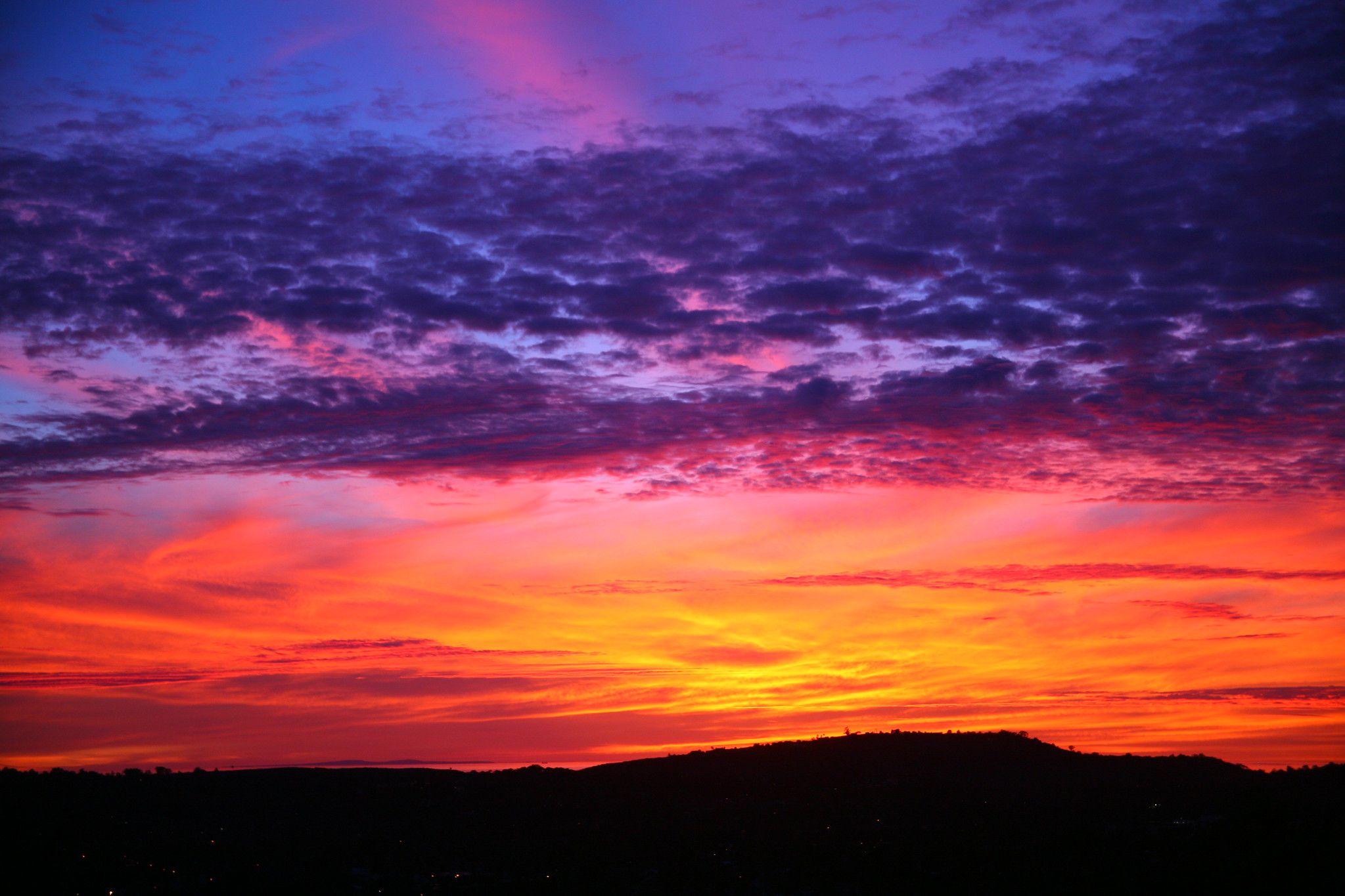 A spectacular sunset over the ocean in Santa Barbara with purples, blues, pinks yellows in the sky.