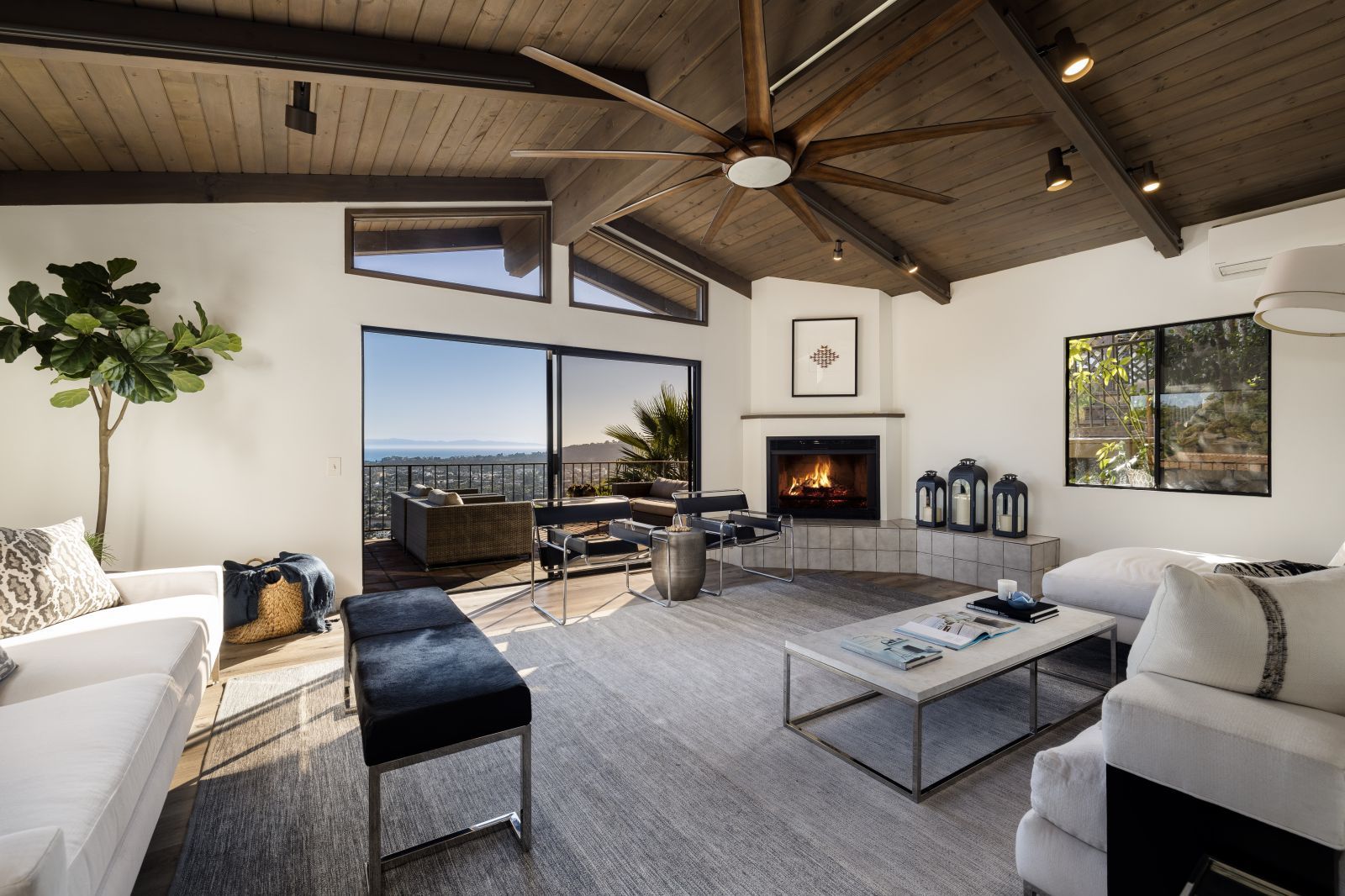 The living room fo a Santa Barbara home for sale with a fireplace and ocean view.