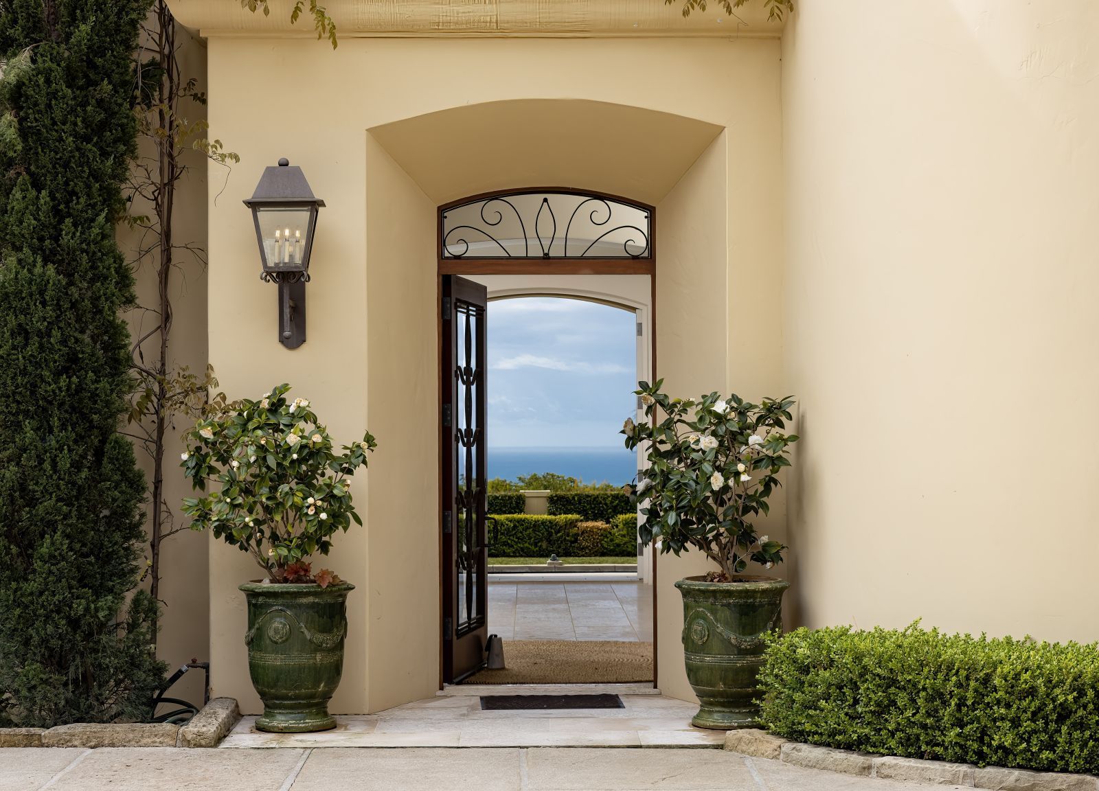 A luxury home's door opening to a spectacular ocean view