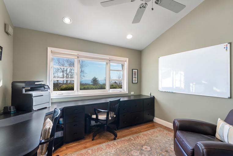 Masculine desk with windows above as an example of a great home office