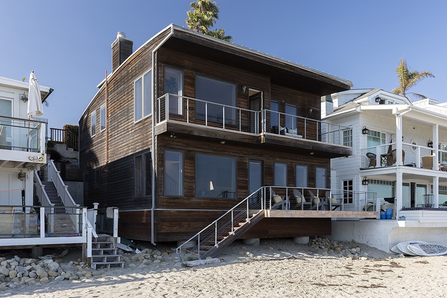 The outside of an Iconic Beach House that sits right on the sand in Miramar Beach.