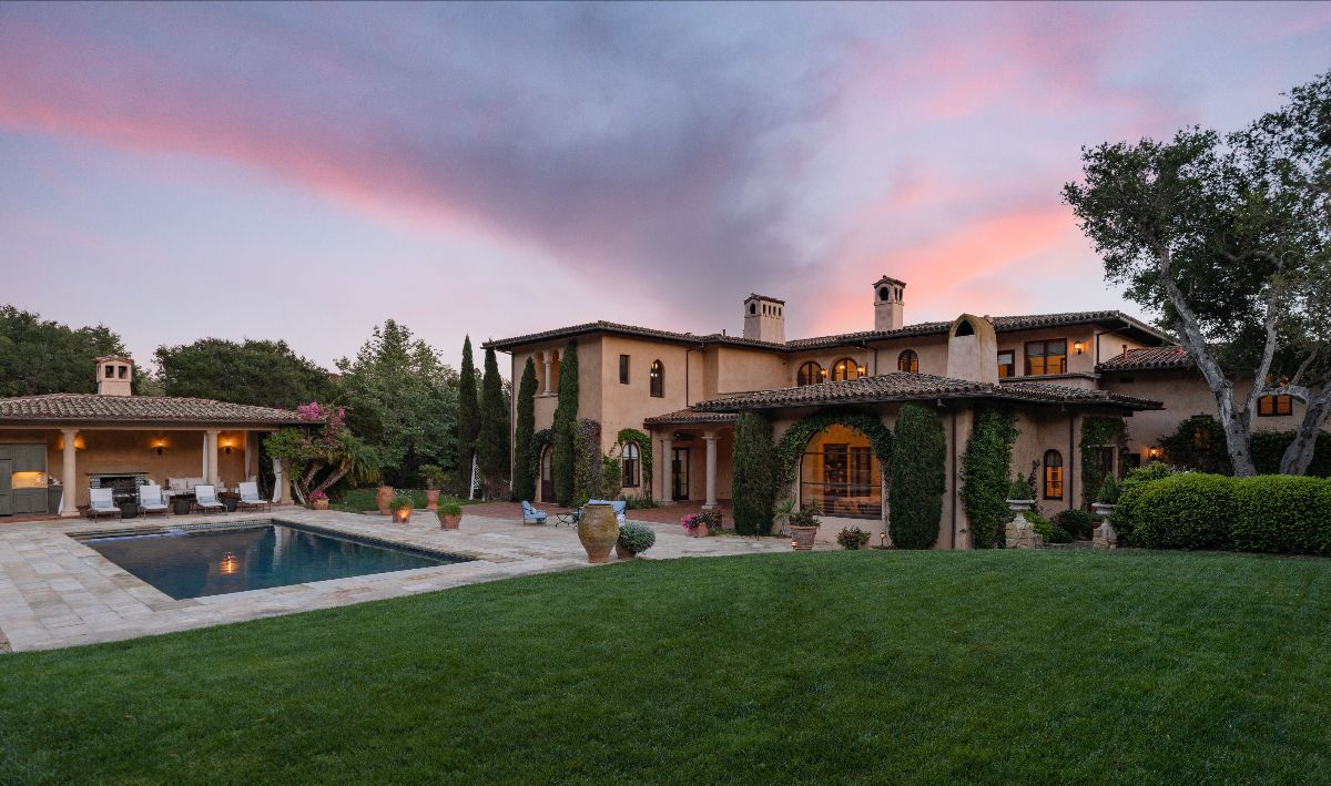 A dramatic Santa Barbara sunset with an Italian styled Montecito Villa for sale in Santa Barbara