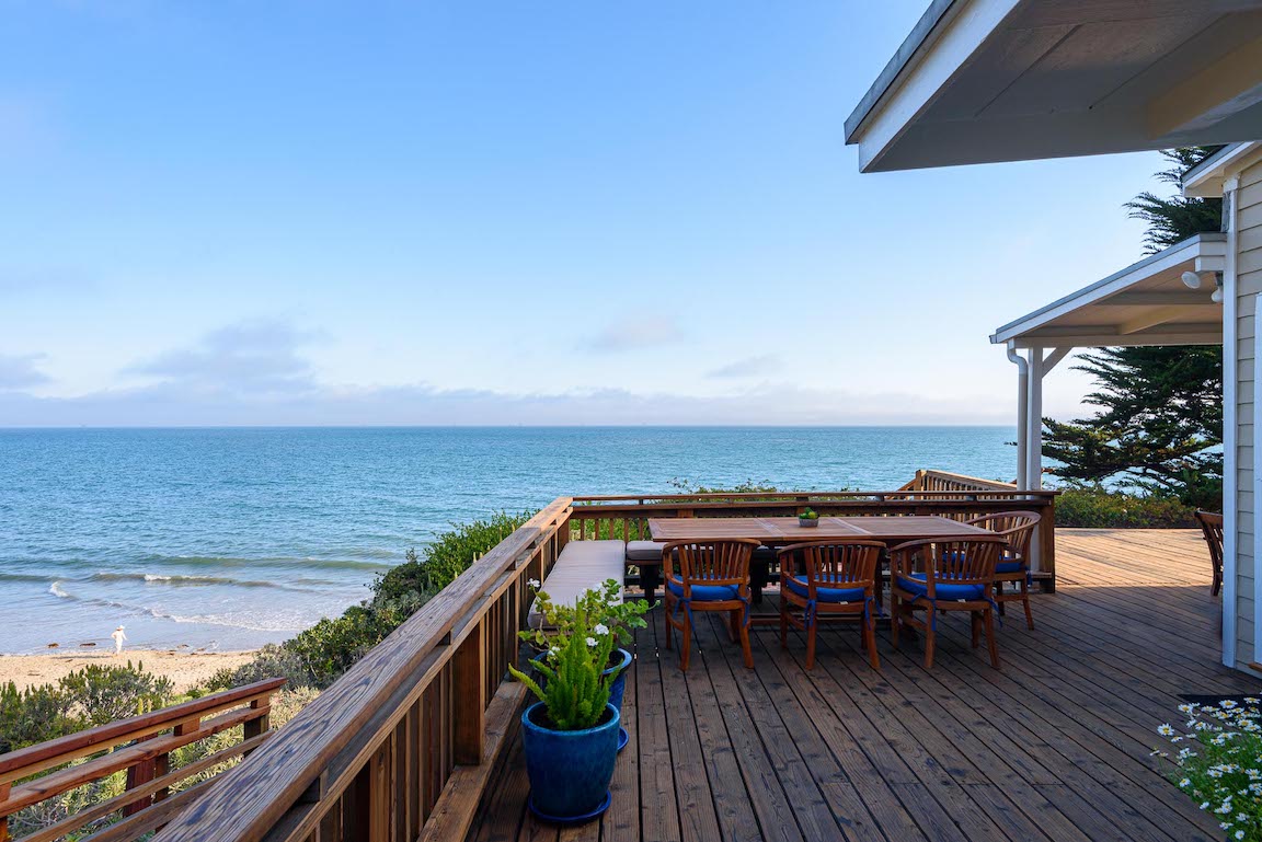 The deck of a home for lease with a beautiful view of the ocean  