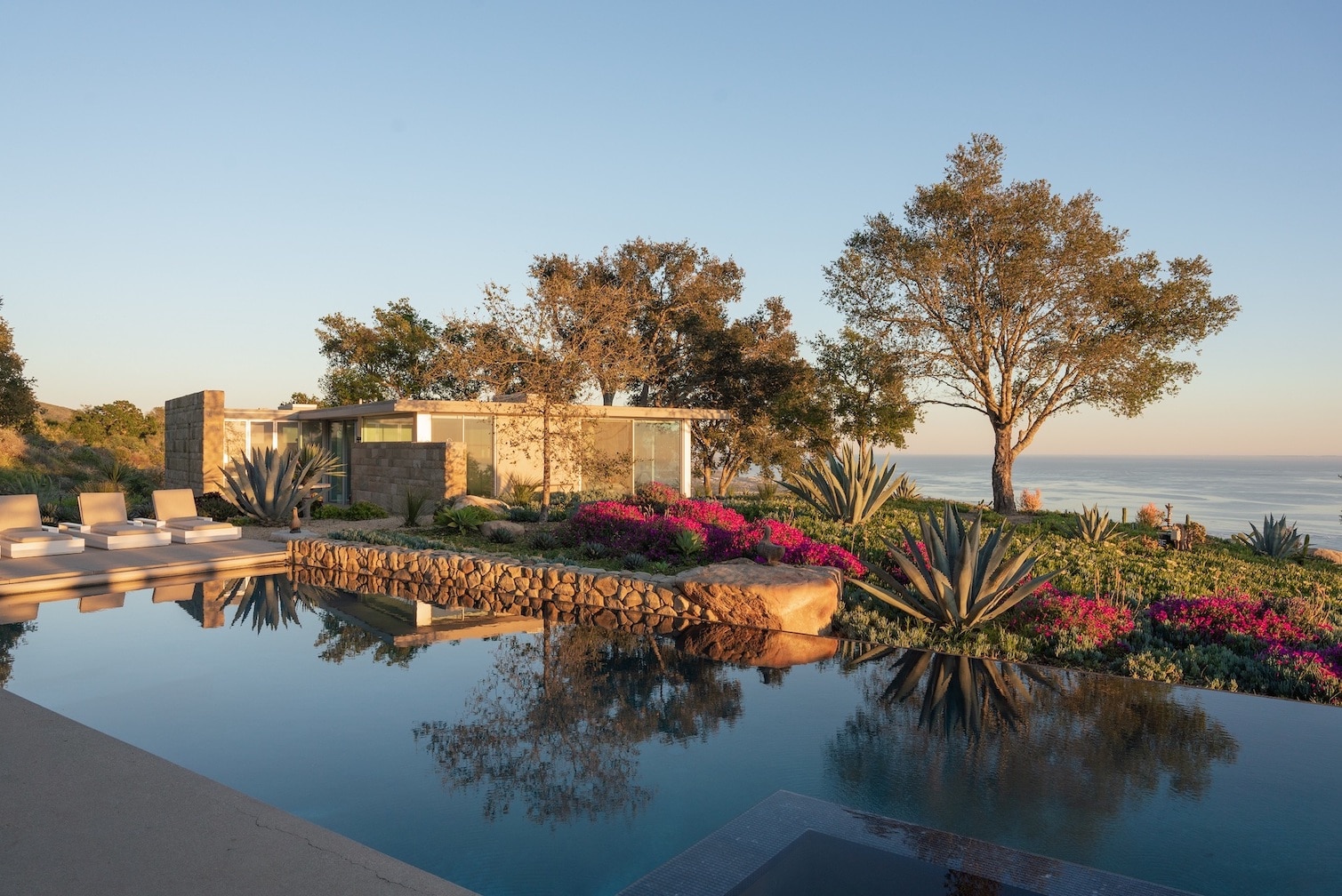 Beautiful pool with infinity edge and cabana in the background