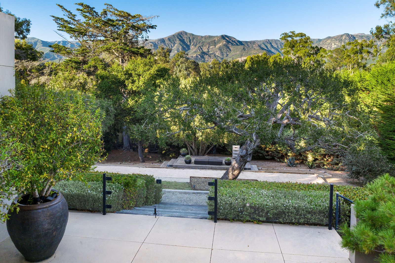 Back patio of a Contemporary home frame by majestic mountains.