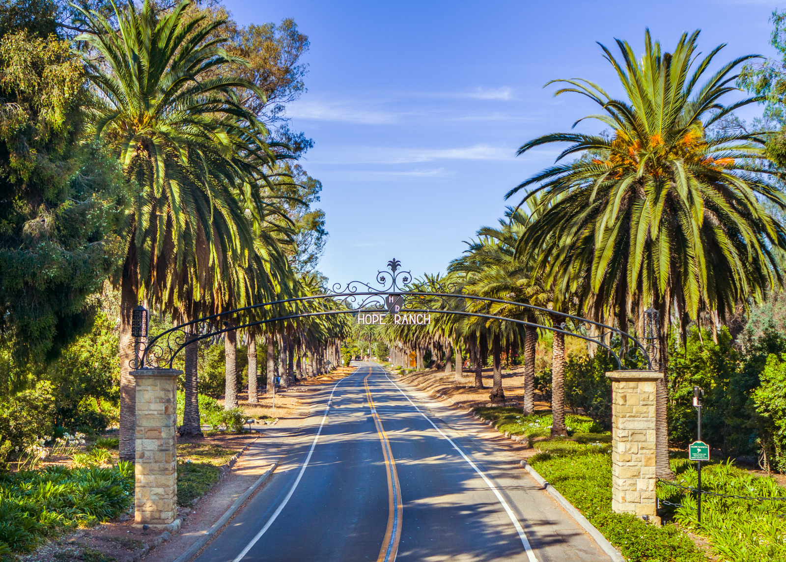 The entrance to Hope Ranch lined with palm trees.