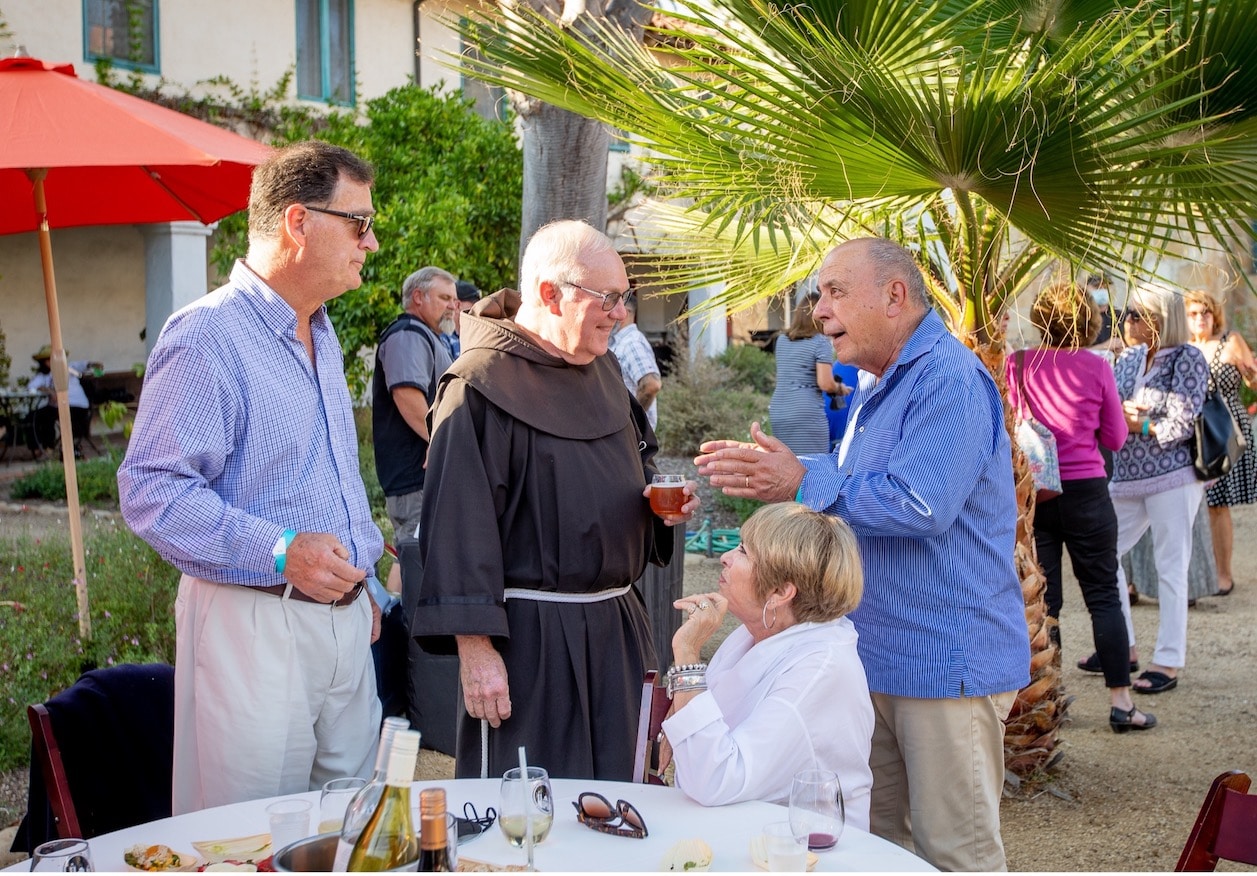 Wine event at the Santa Barbara Mission with a monk and guests