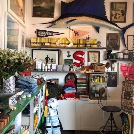 Th einside of a gallery in Montecito with art on the walls including a big fish