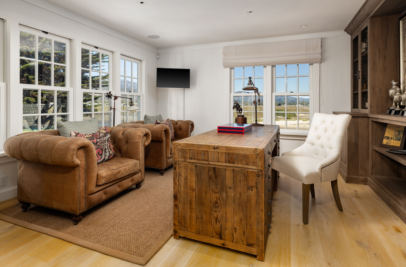 This home office features leather and wood for an upscale look and vibe.