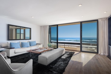 The living room of a Bonnymede condo with sliding door that opens to the ocean