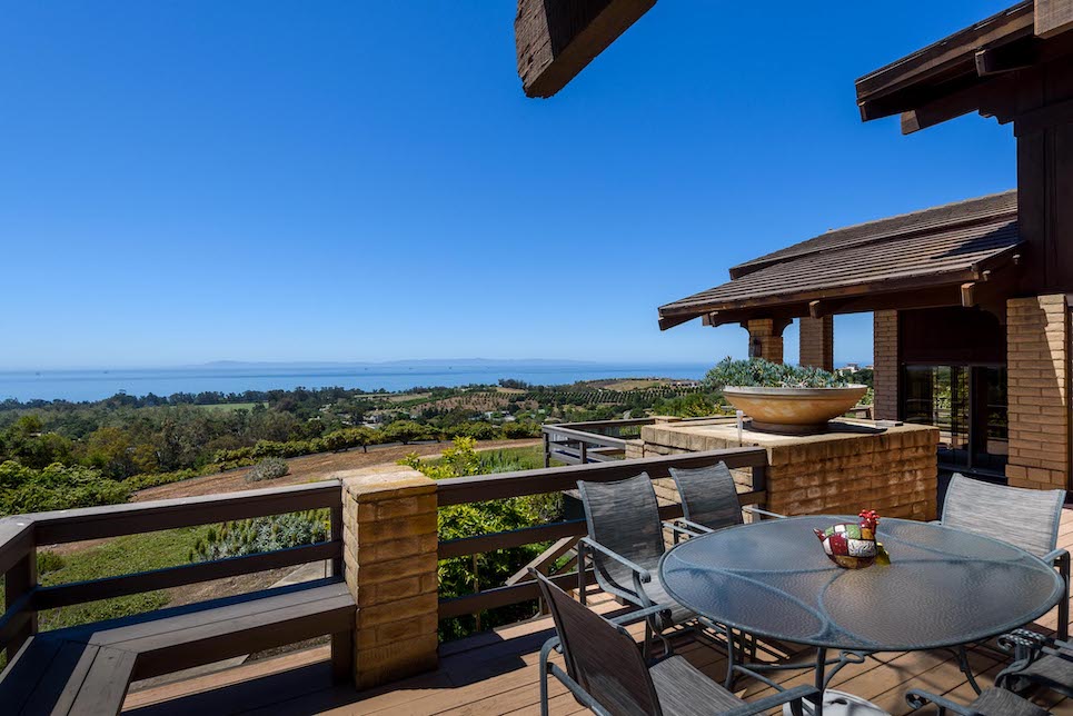 The patio of a Carpinteria home for sale that looks over lots of land s an example of Outdoor Living Spaces for Luxury Homes