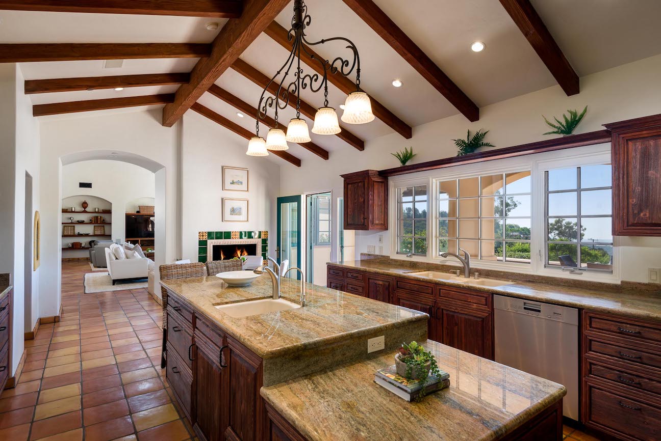 Upscale kitchen with beamed ceiling.