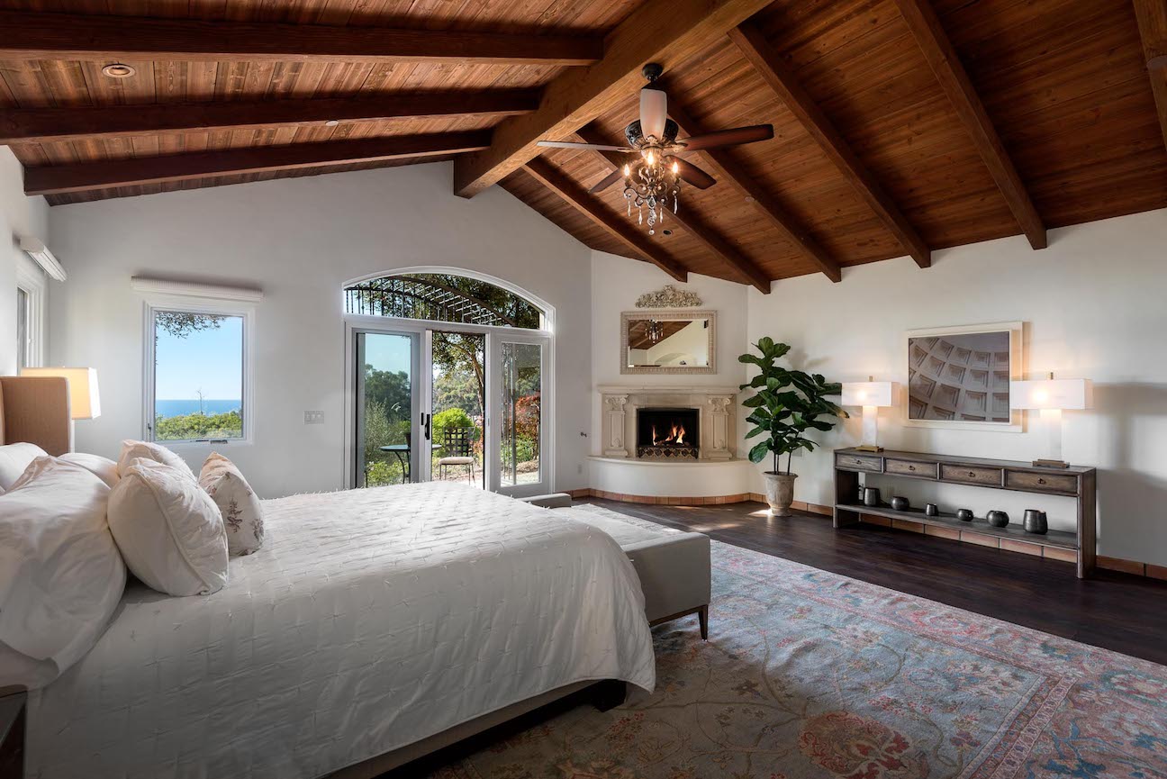 Master bedroom with a cozy fireplace.  