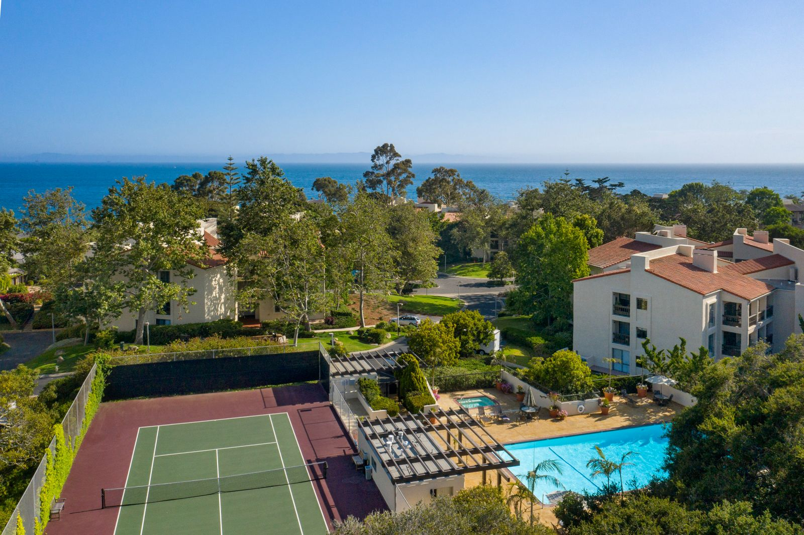 Santa Barbara coastal community featuring ocean views, tennis courts, resort-style pool, and luxury residences, offering premier California coastal living and recreation.