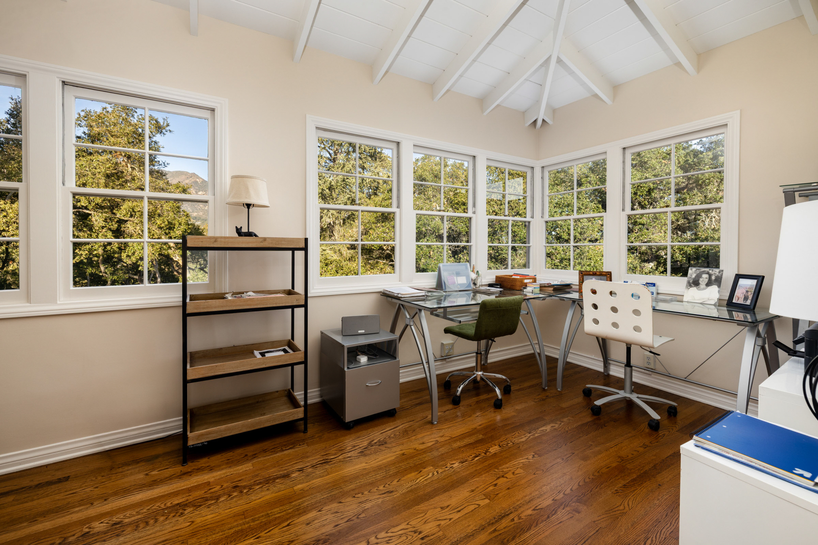 The windows in this home office add the touch of nature and an incredible view to work from.