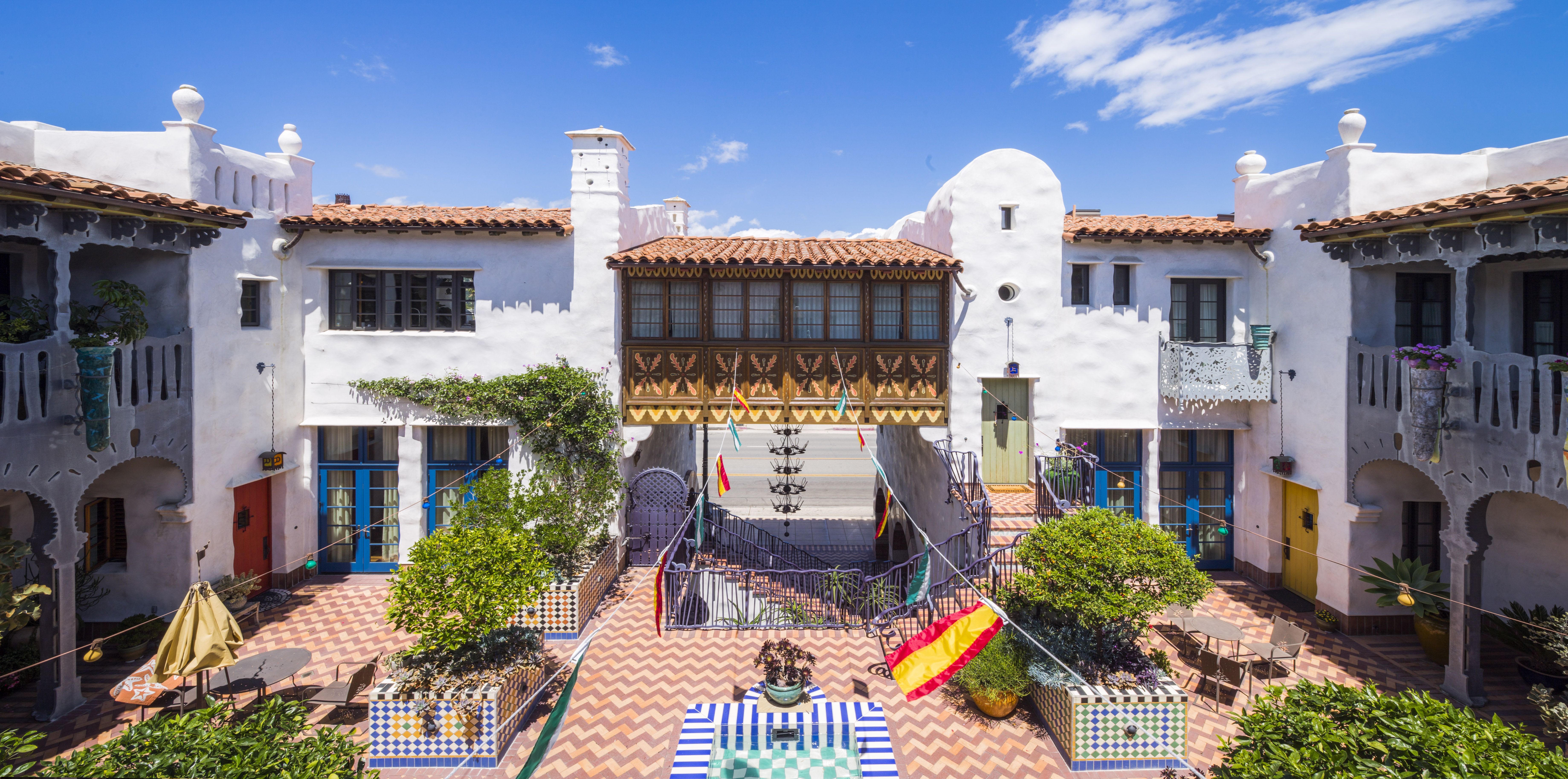 The courtyard of a Jeff Shelton-designed two-story building that incorporates traditional Mediterranean design elements and Shelton's bold, whimsical, contemporary twists.