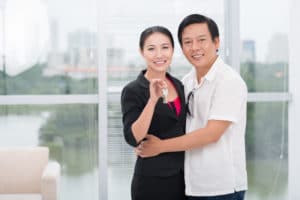 Portrait of a mid-aged Vietnamese couple in their new house