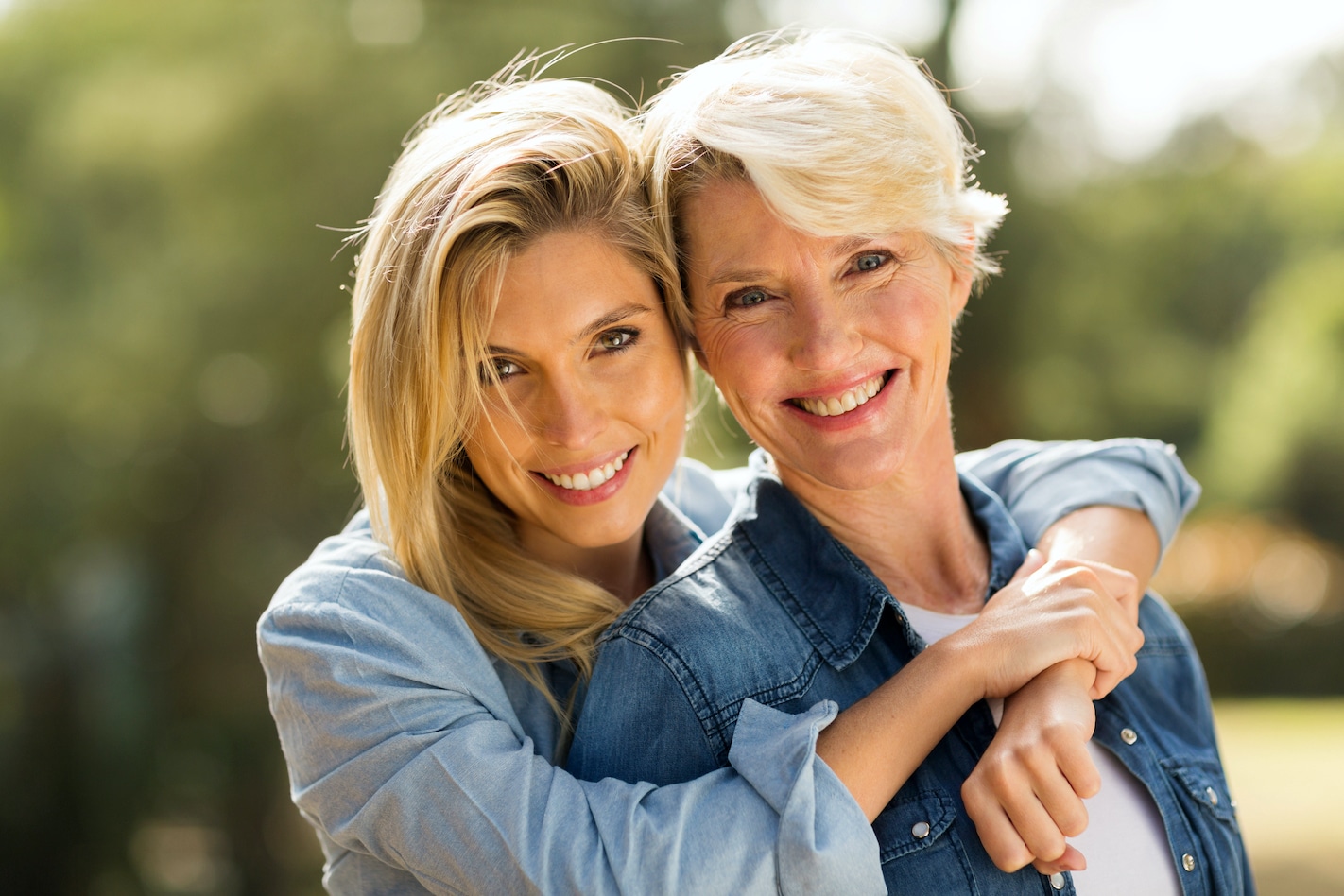 close up portrait of mother and daughter hugging