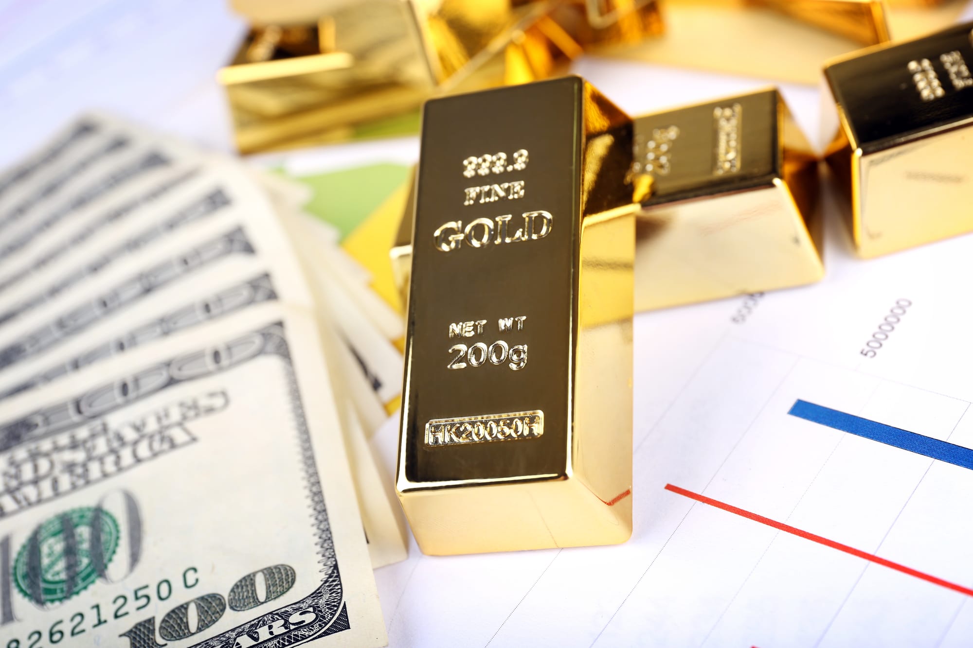 Gold bullion with money on table close up