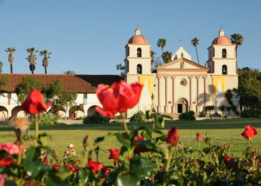 Mission Santa Barbara with red roses in the foreground