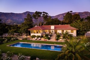 Montecito home for sale, sparkling pool in the foreground, surrounded by magnificent mountains