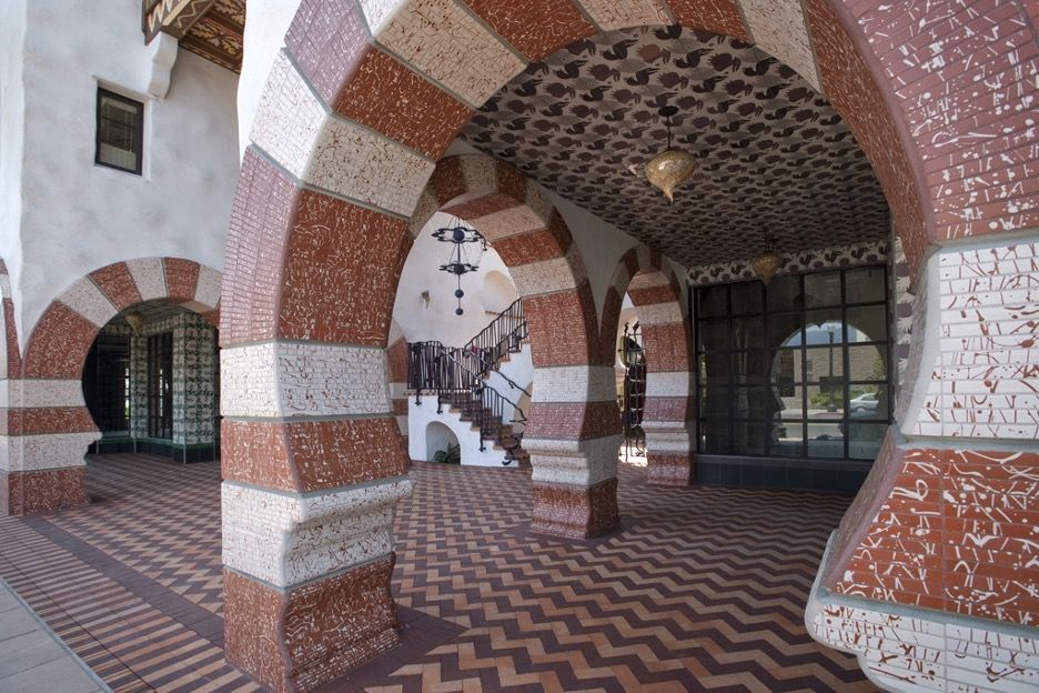 A portion of a highly stylized courtyard at a Jeff Shelton-designed condo complex, showing large, modified Ogee arches.
