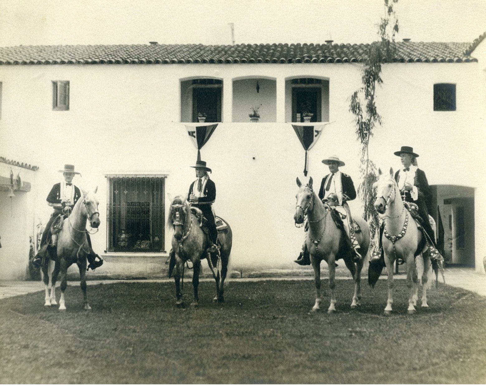 A vintage image of four men on horseback, the founding fathers of the Santa Barbara Fiesta.