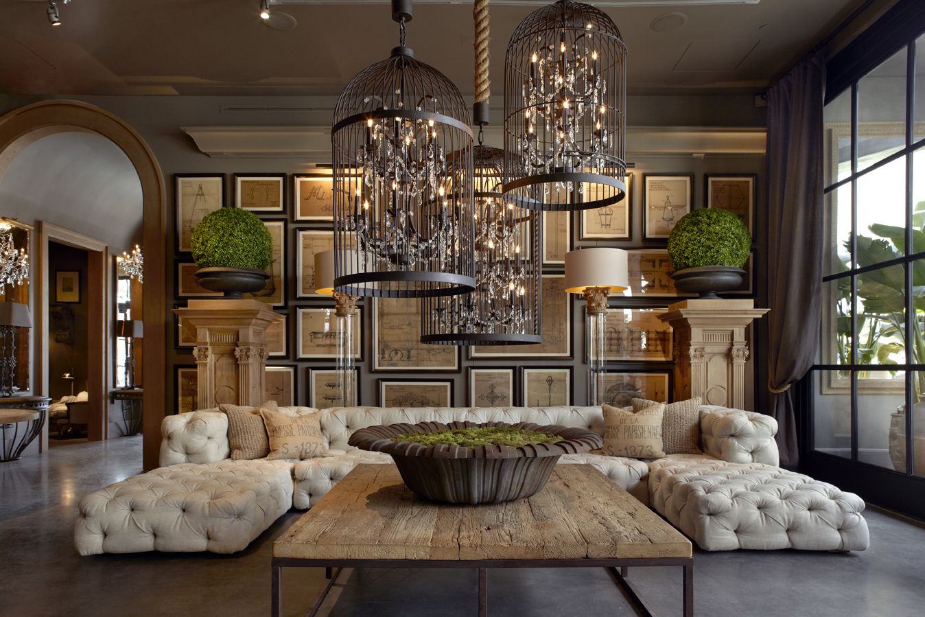 The floor showroom at RH showcasing a luxurious living room with chandeliers