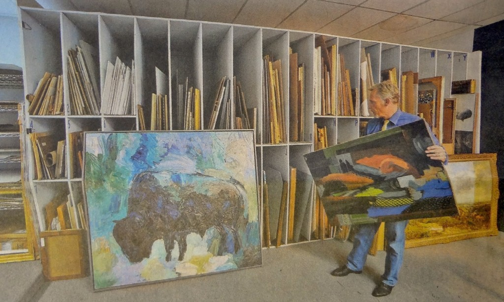 A man inside a luxury storage facility with rarte art work.