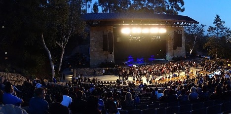 Santa Barbara Bowl at night with a crowd in front of the lighted stage