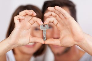 Young couple holding a house key together