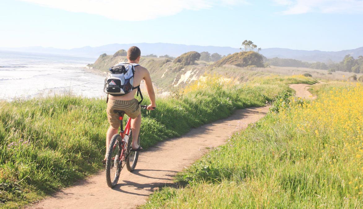 Man riding a bike along the california coast