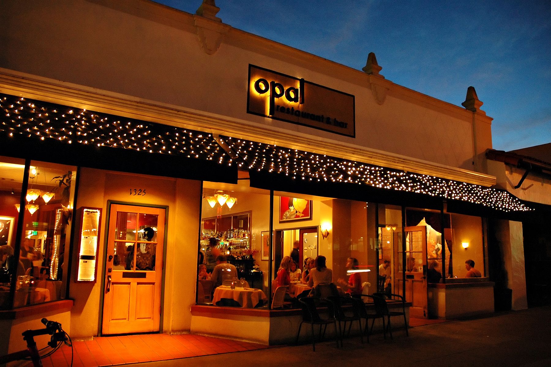 The outside of the Opal restaurant and bar illuminated at night