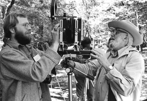 Alan Ross (left) assists Ansel Adams (right) with the camera, 1977.