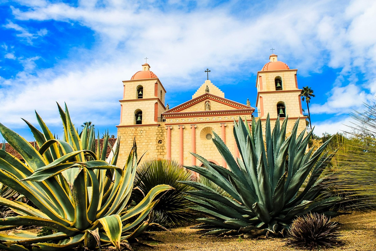The old Mission Santa Barbara with a blue sky filled with fluffy clouds.