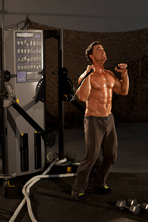 Alternating Cable Shoulder Press — starting position, working the shoulders