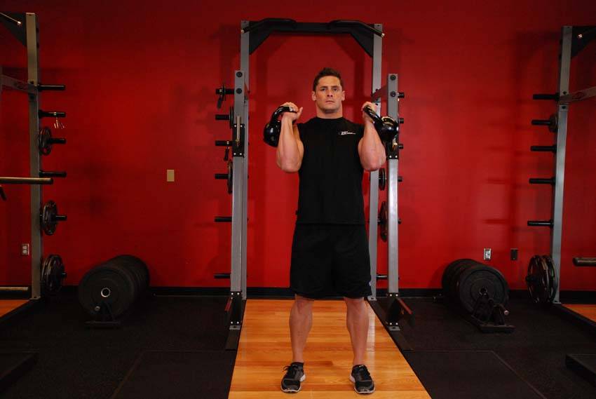 Alternating Kettlebell Press — starting position, working the shoulders