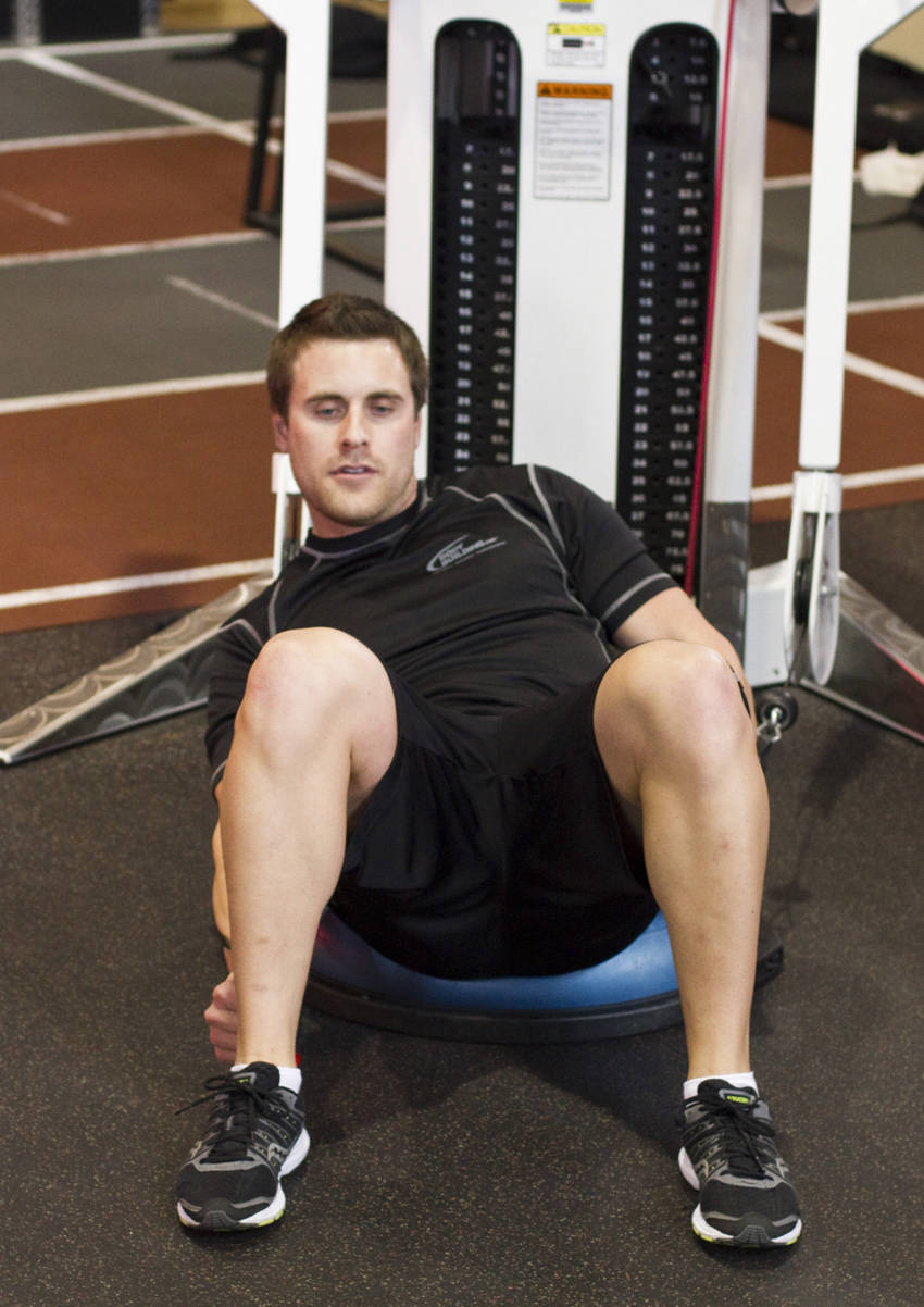 Bosu Ball Cable Crunch With Side Bends — end position, working the abs