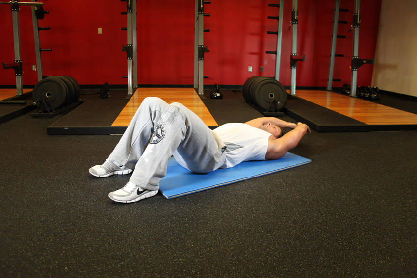 Crunch - Hands Overhead — starting position, working the abs
