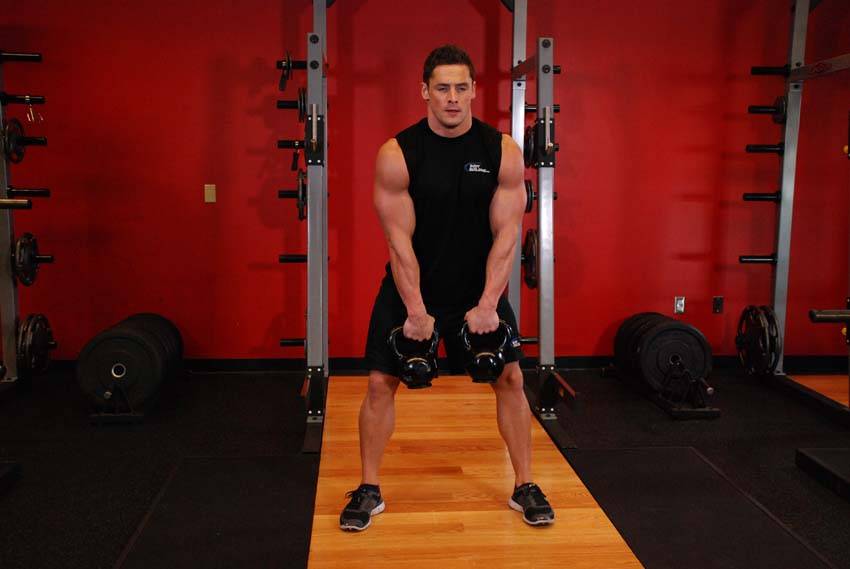Double Kettlebell Alternating Hang Clean — starting position, working the hamstrings